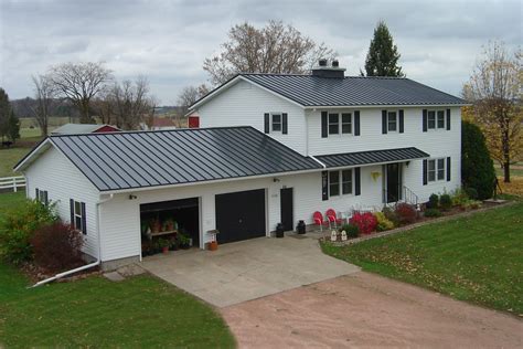 white house with gray metal roof|houses with charcoal metal roof.